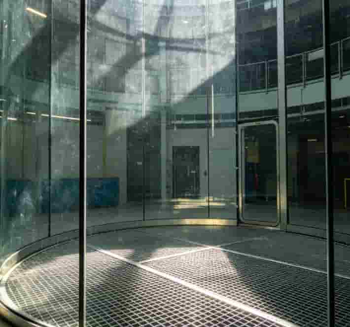 Empty indoor skydiving vertical wind tunnel with transparent walls and a metal floor grate