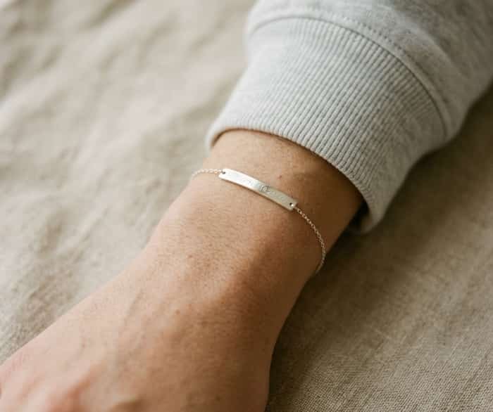 Engraved bar coordinates bracelet on wrist