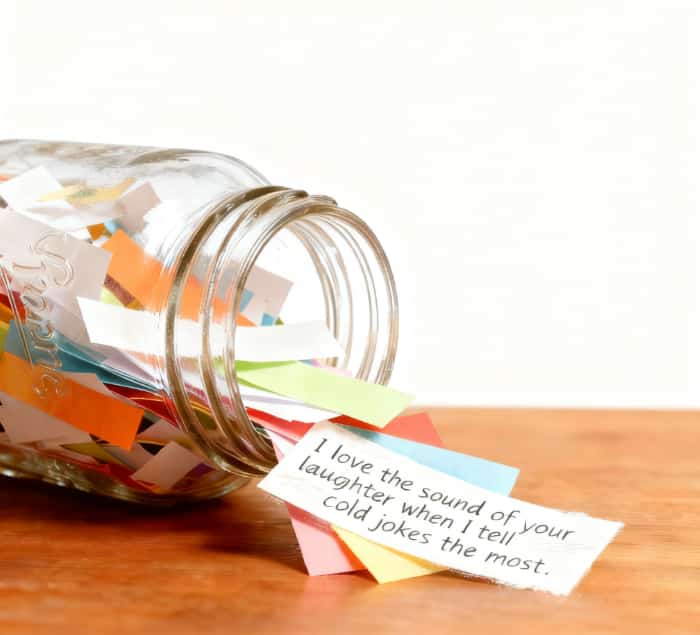A glass jar filled with colorful handwritten love notes, a simple and meaningful DIY gift