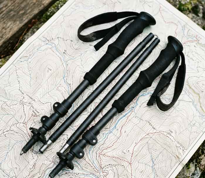 Carbon fiber folding trekking poles on a topographic map