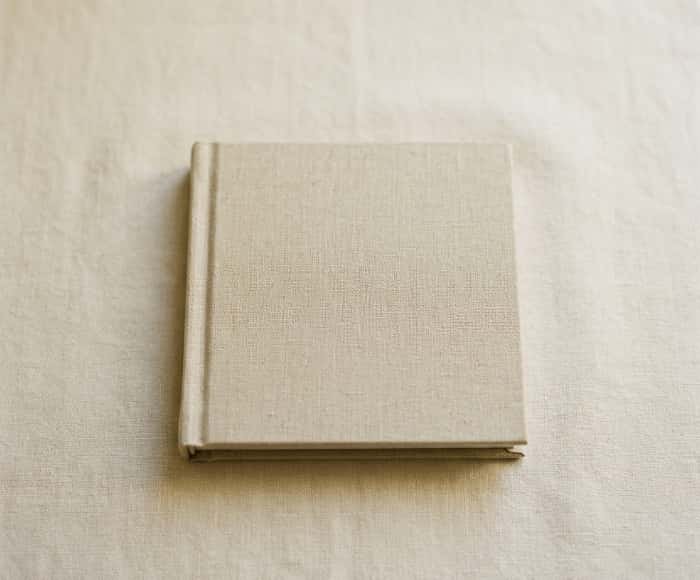 Custom linen-covered hardcover photo book on light fabric