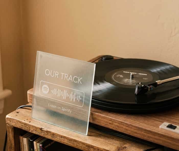 Frosted glass Spotify plaque with song code next to a record player