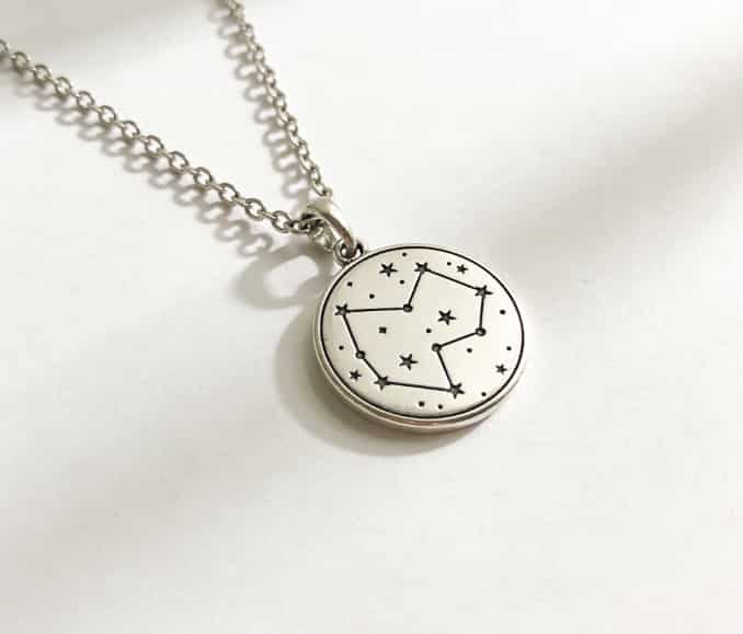 Personalized star map necklace on a table