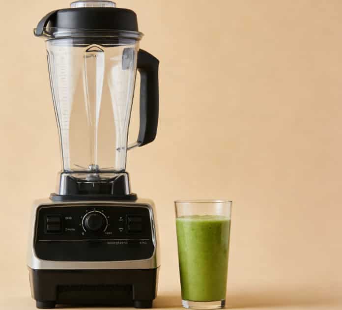 High-speed blender making green smoothie