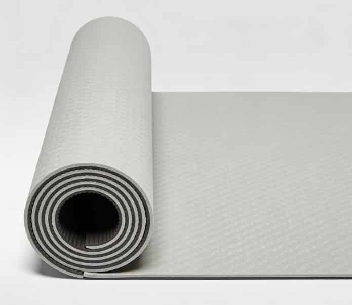 Premium yoga mat unrolled on floor