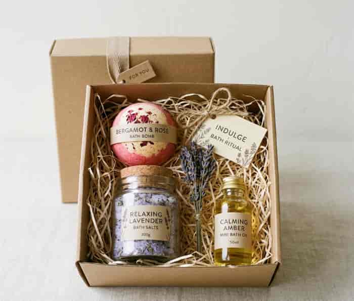Curated bath gift box with bath bomb, salts, and mini bottle