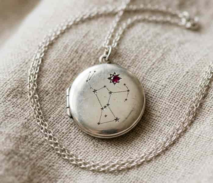 Locket necklace engraved with a constellation and tiny birthstone