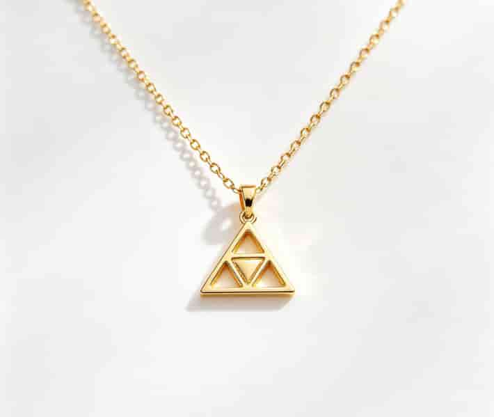 Minimalist 14k gold-plated necklace with a small Triforce pendant on white background
