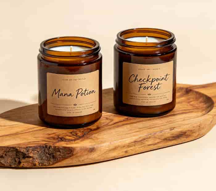 Two handmade soy candles labeled Mana Potion and Checkpoint Forest on a wooden tray