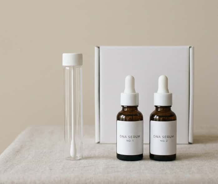 DNA personalized skincare kit with test tubes and serum bottles on clean background