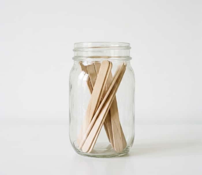 Mason jar with wooden popsicle sticks for DIY date night idea